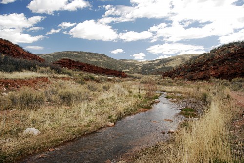 Sand Creek winds through red rock canyons