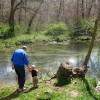 Grandpa and Gabe throwing rocks in the river